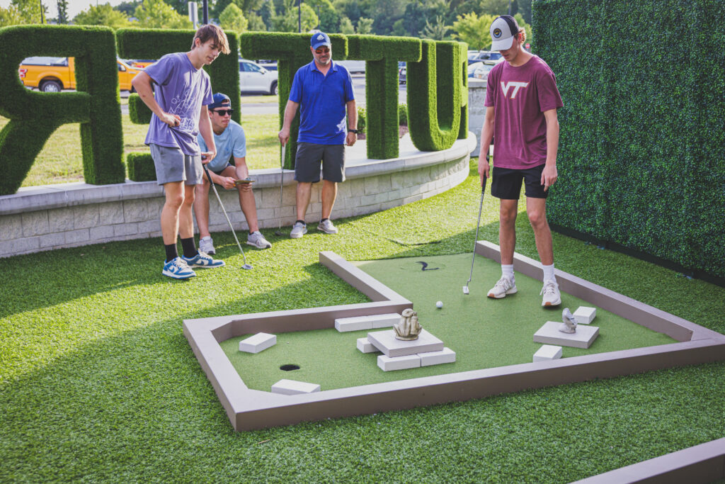 A stroll through Drive Shack's mini golf course reveals Puttery's whimsical outdoor art garden, where each hole is a masterpiece.
